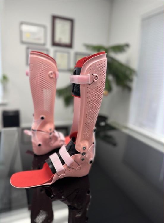 Pink custom hinged ankle foot orthoses with a breathable lattice design, made by WingTek near Regina, Saskatchewan