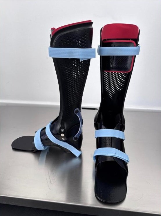 A hinged ankle foot orthosis (AFO) beside a solid AFO, made by WingTek