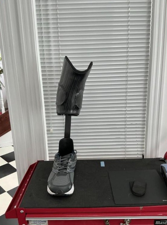 Custom carbon patellar tendon bearing (PTB) ankle foot orthosis in a shoe, made by WingTek