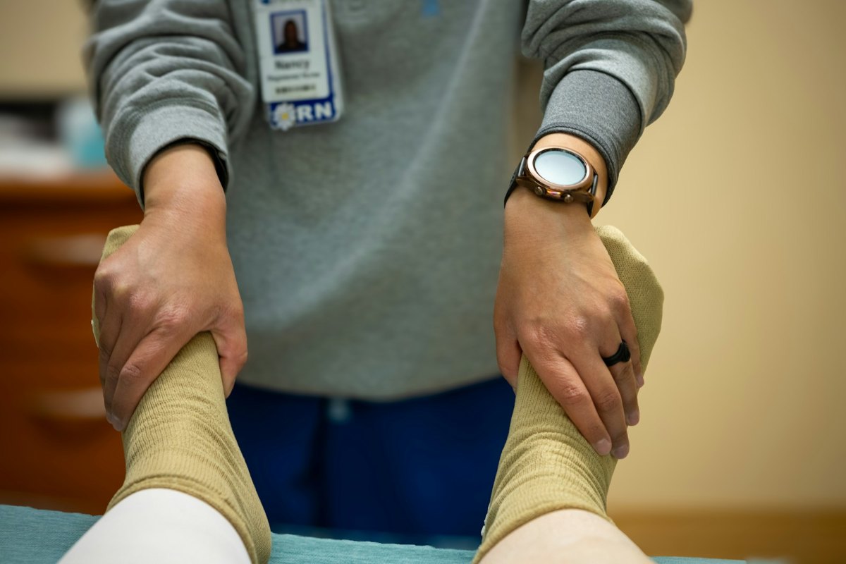 Clinician checking a patient's feet during a foot assessment