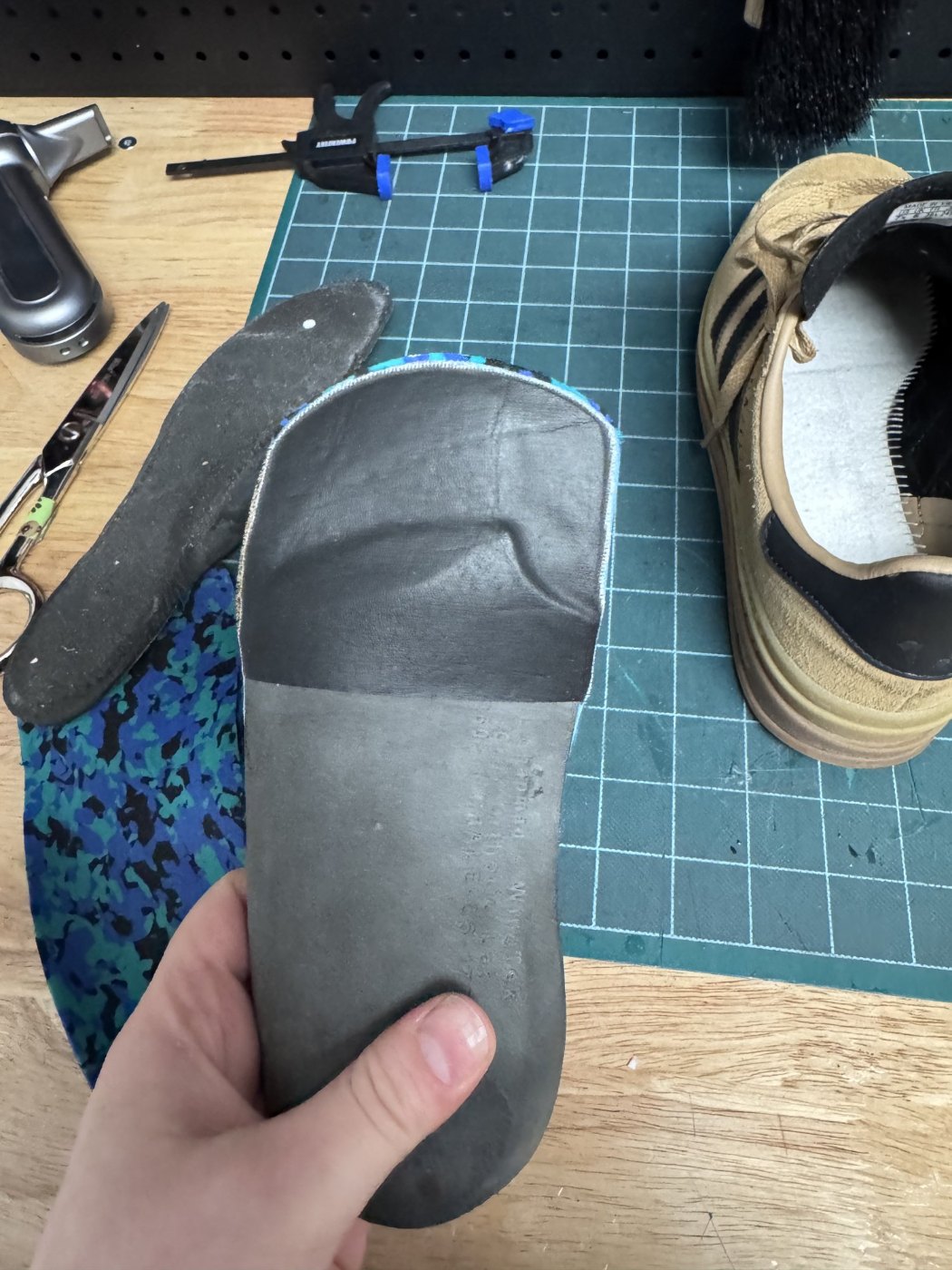 Underside of a custom foot orthotic showing the grey 3D printed shell