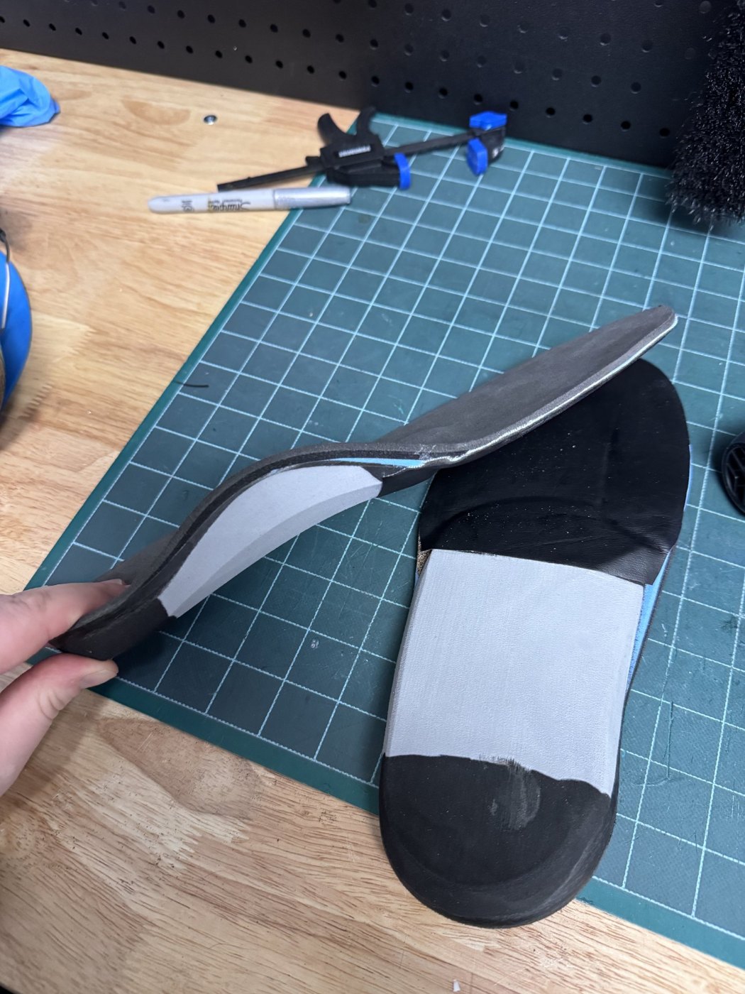 Custom foot orthotic with cushioning layers being finished in the WingTek lab