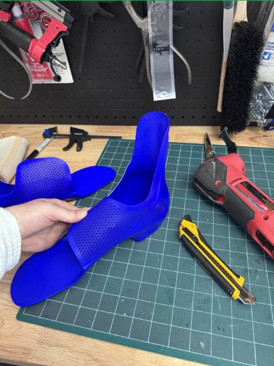 Blue custom 3D printed supramalleolar orthosis (SMO) shown from the side, made by WingTek